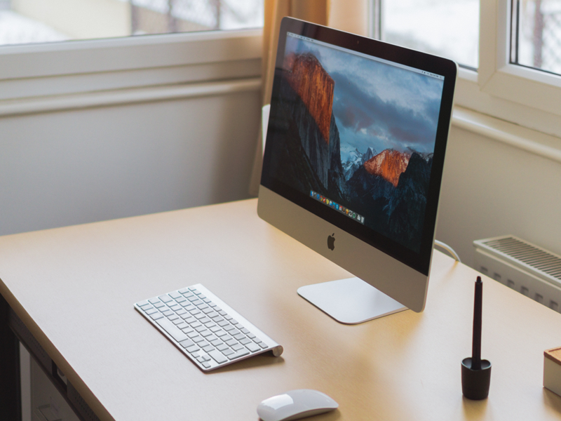 Desk with mac computer on it